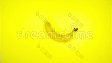 停止香蕉在黄色背景上的运动。 香蕉运动。 `健康食品理念.. 动画循环电影与移动香蕉。 耦合